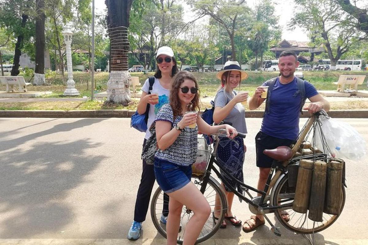 a group of people standing next to a bike