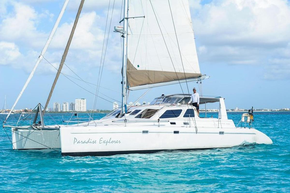 a man standing on a sail boat in the water