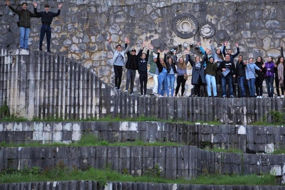 a group of people standing on top of a fence