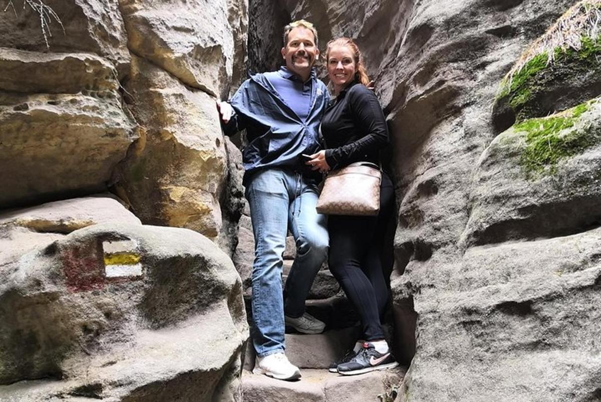 a man and a woman sitting in a rock formation