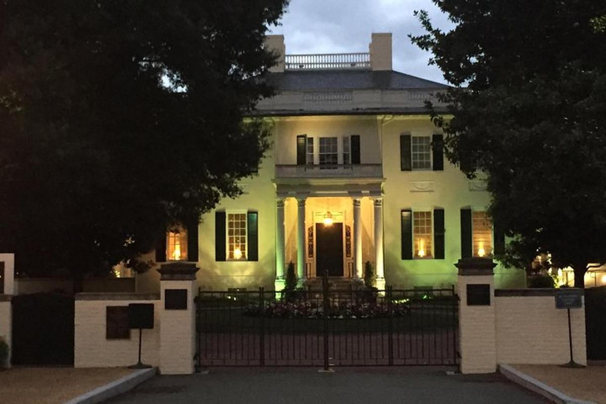 a white house with a gate in front of it