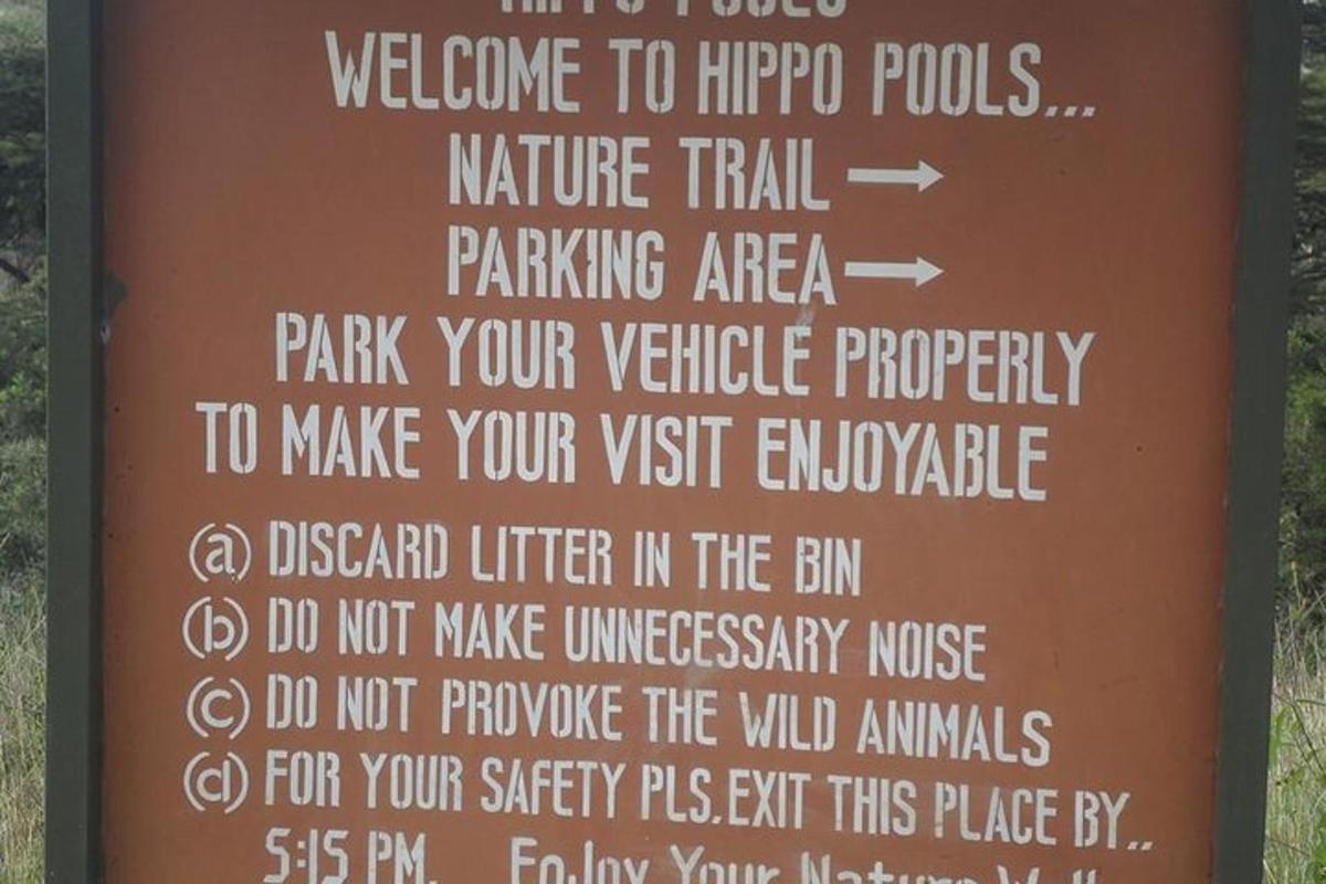 a sign for a wildlife park with a bunch of instructions