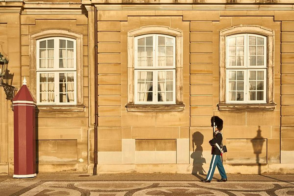 two people walking down a street in front of a building