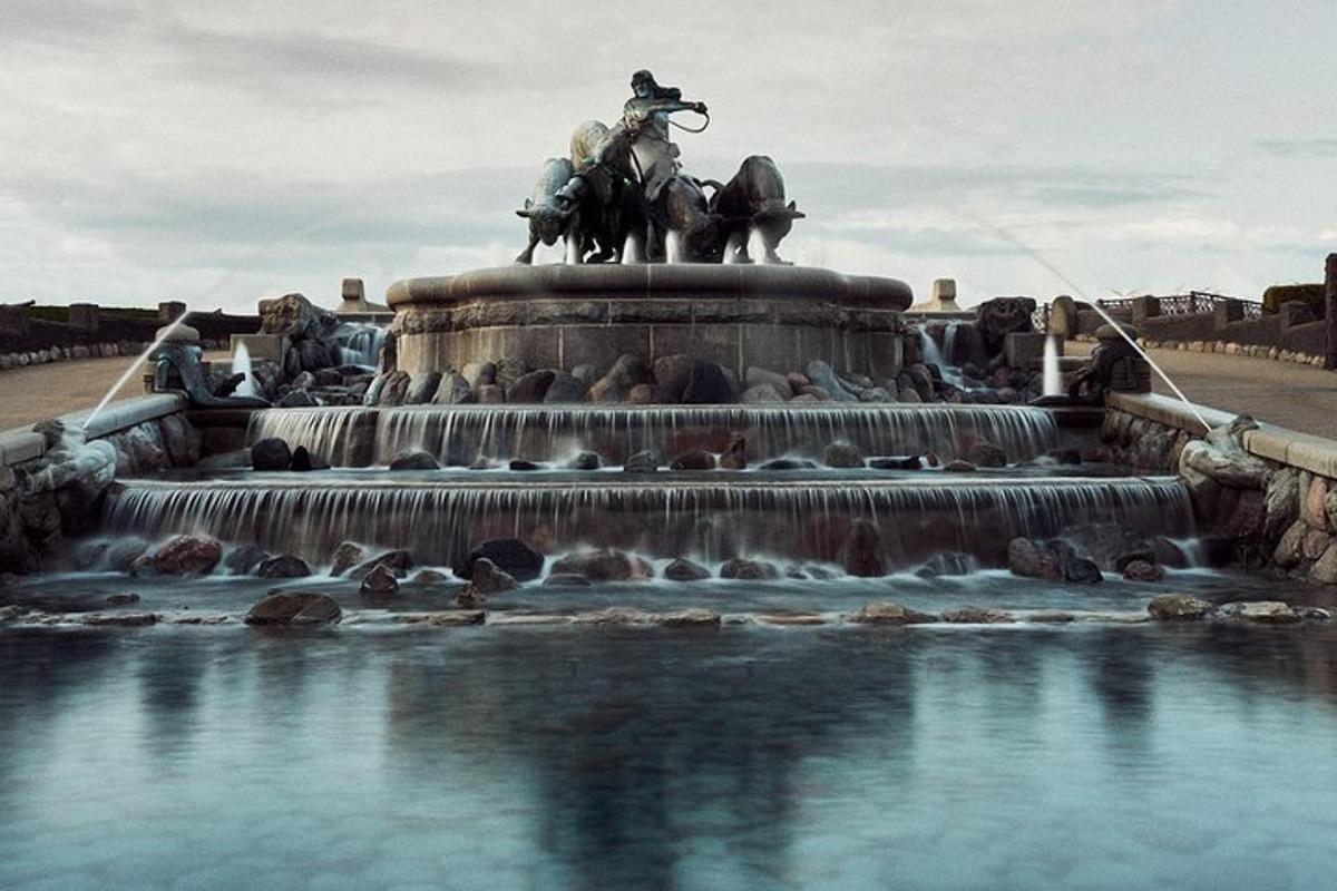 a statue of a man on horses in a fountain