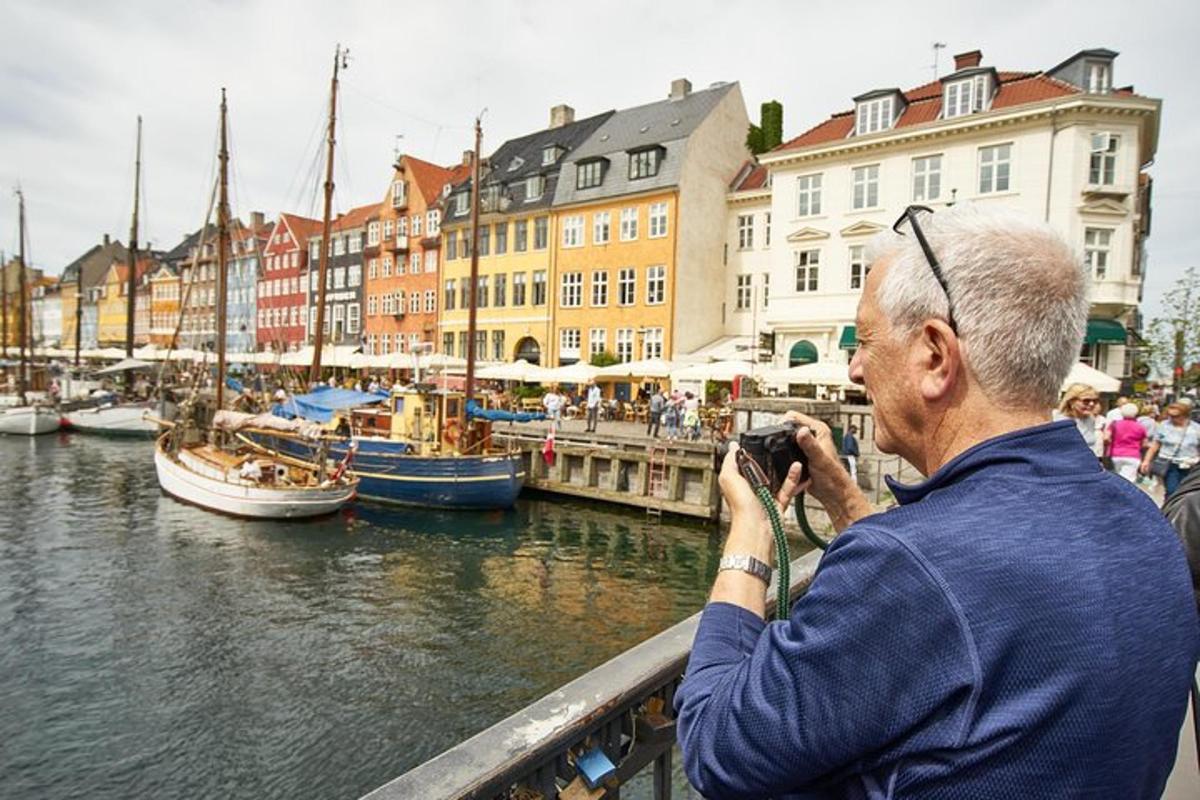 a man taking a picture of boats in the water