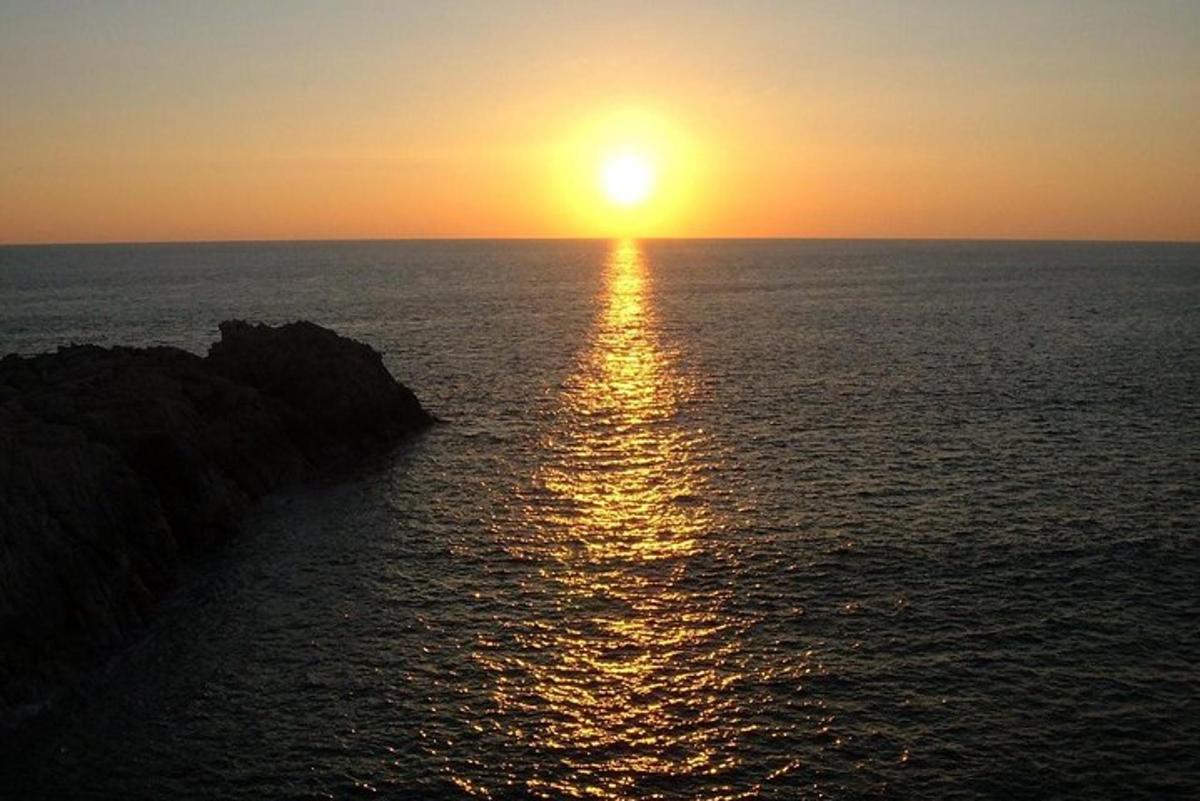 a sunset over the ocean with the sun setting