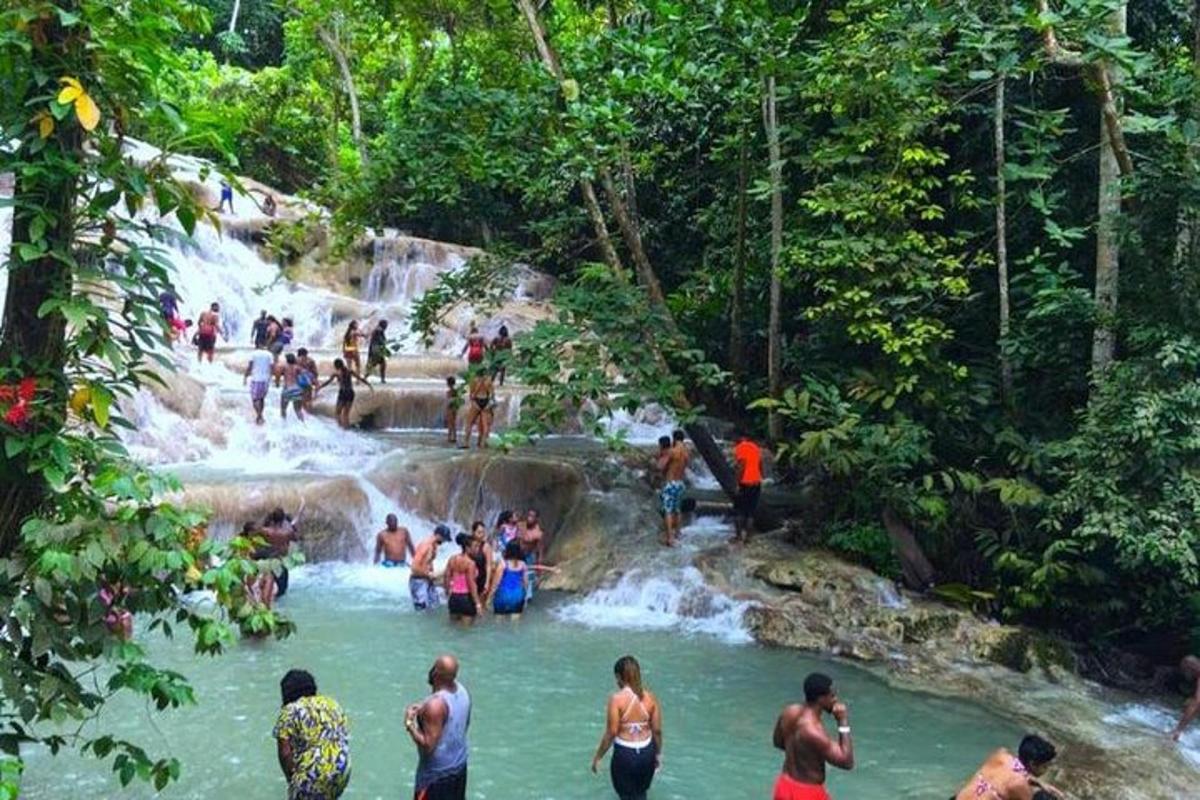 um grupo de pessoas em pé em uma cachoeira