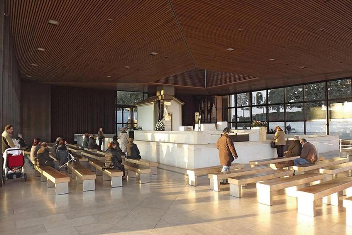 a group of people sitting on benches in a building
