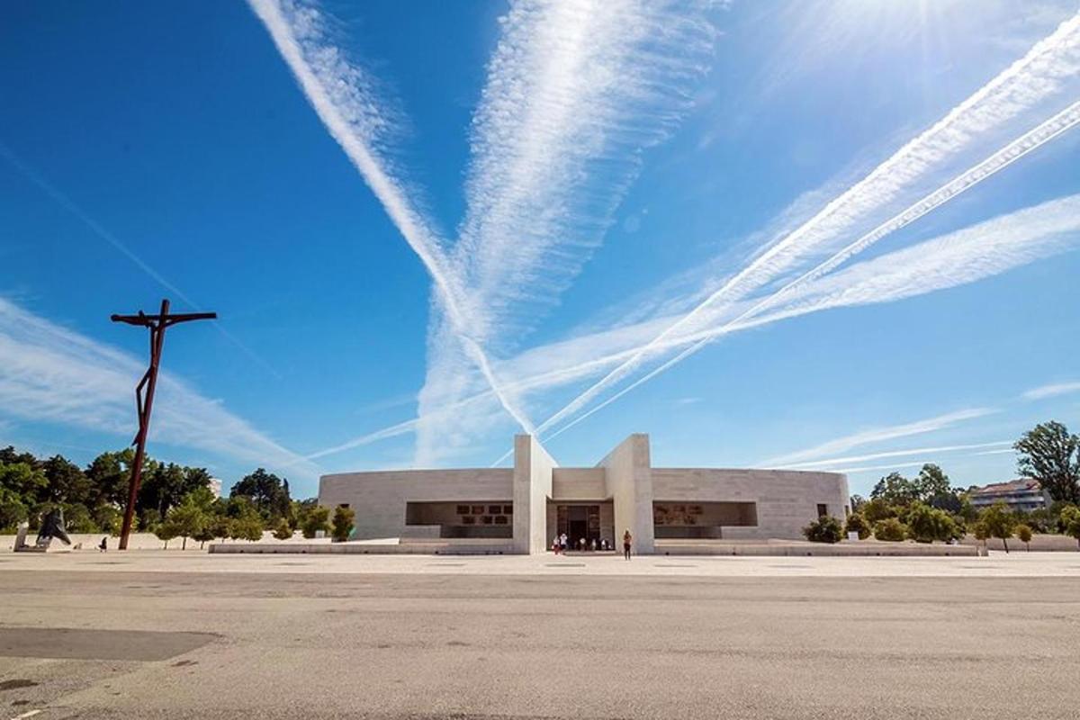 a church with a cross in front of a sky