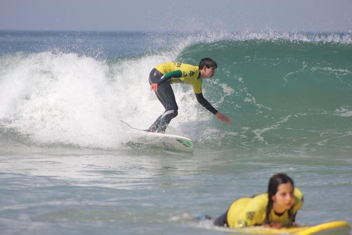 two people riding a wave on surfboards in the ocean