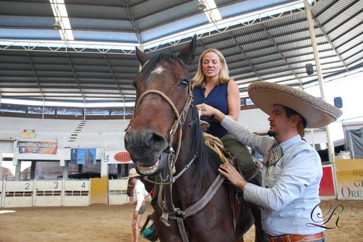 a woman sitting on a horse with a man