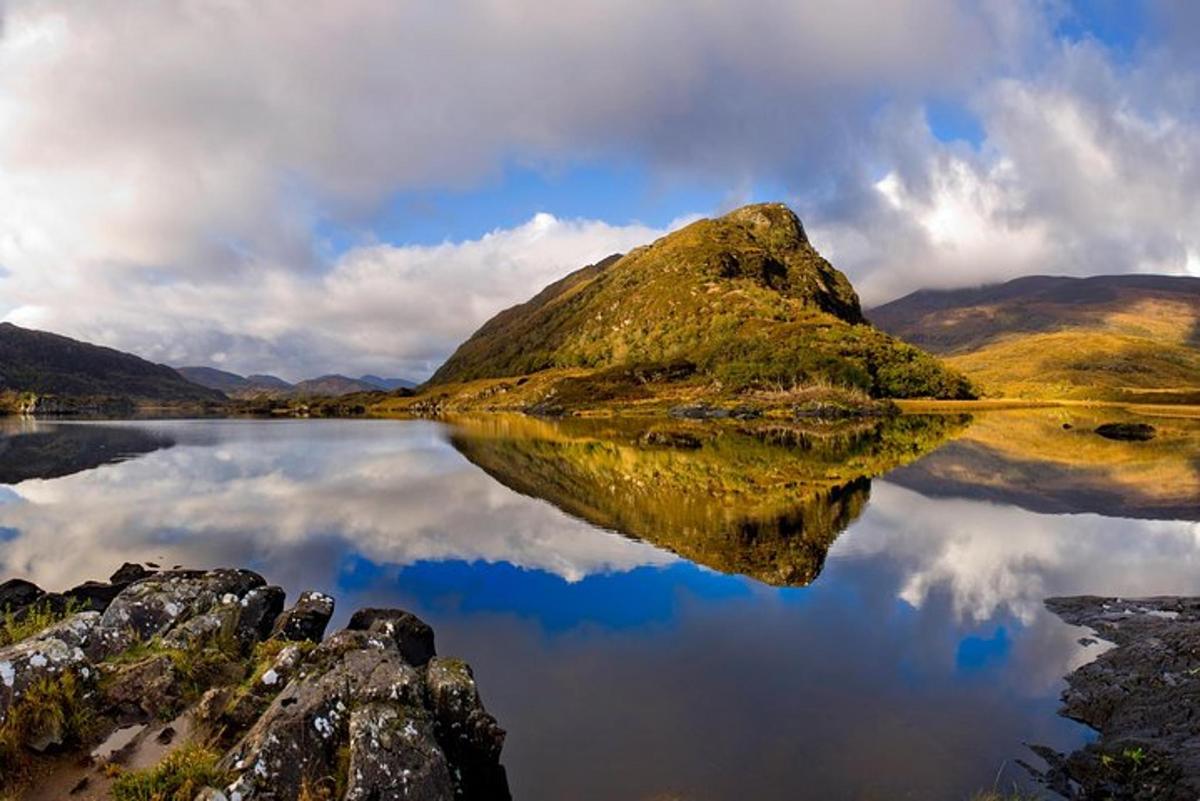 a reflection of a mountain in a body of water