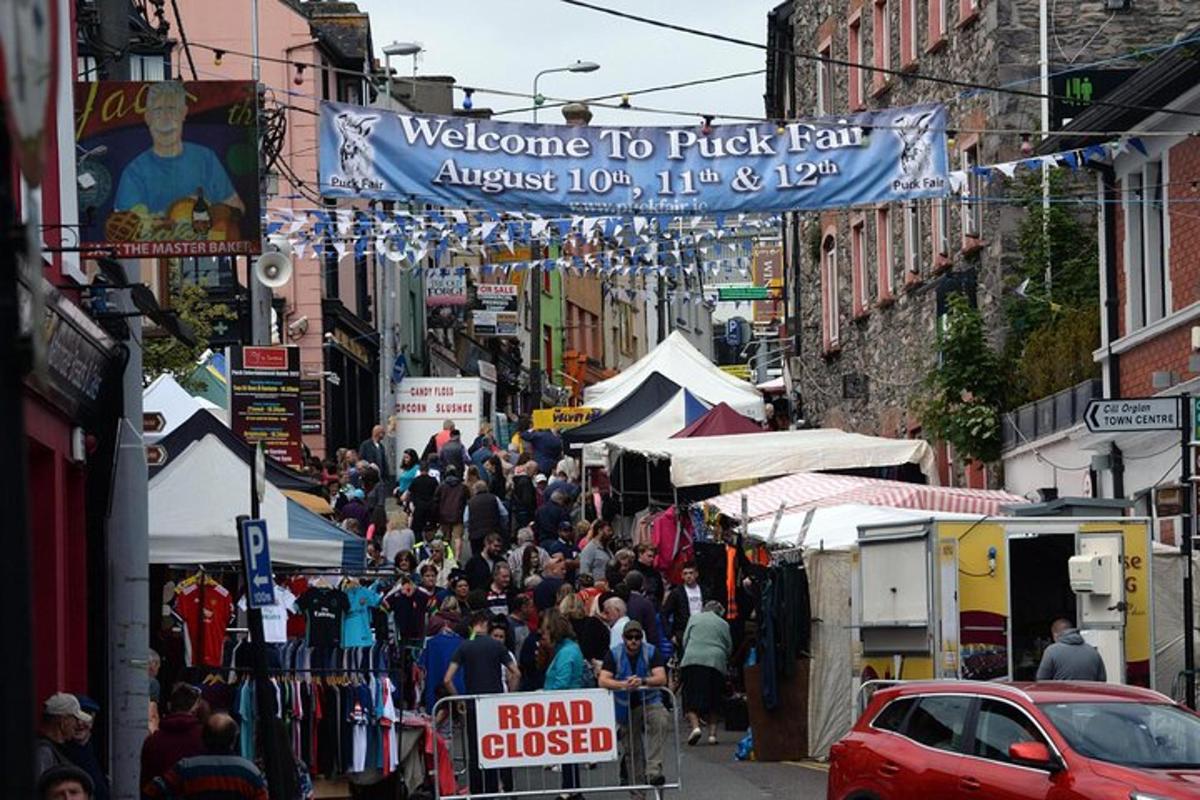 a crowd of people walking down a busy street at a market