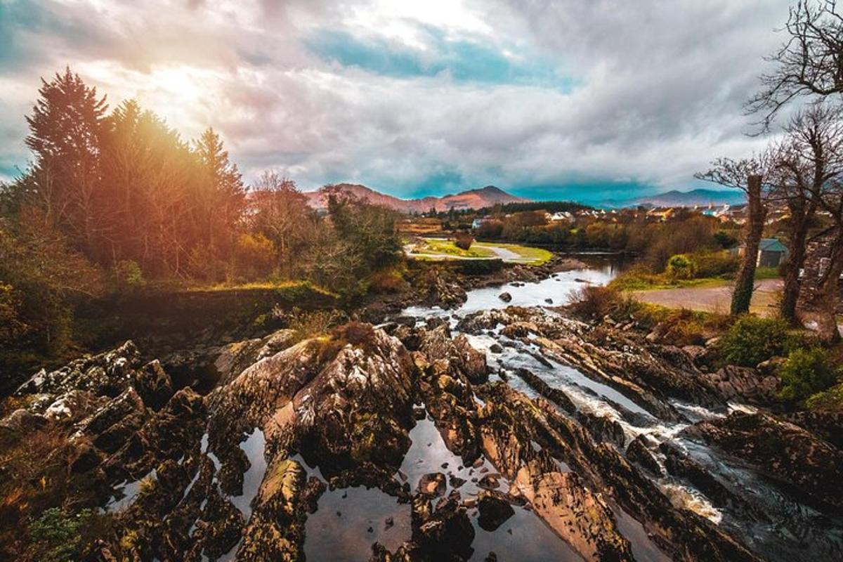 a river with rocks and the sun shining