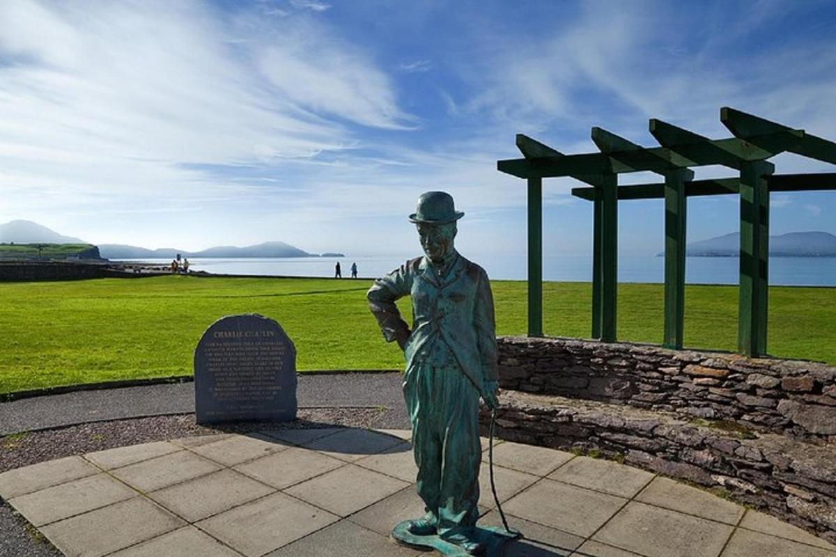 a statue of a man standing next to a wall