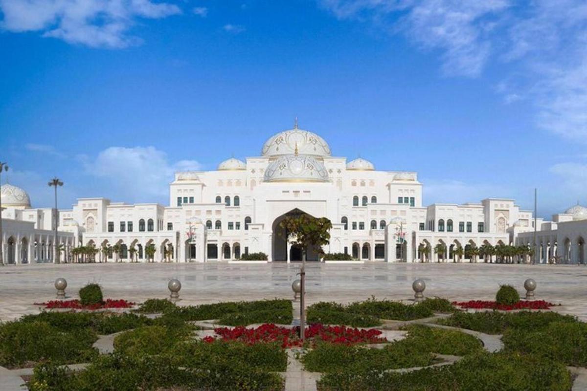 a large white building with a courtyard in front of it