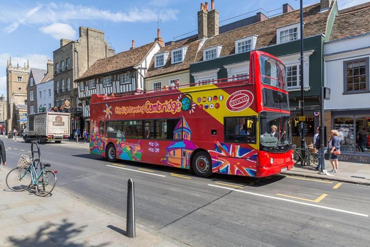 a red double decker bus on a city street