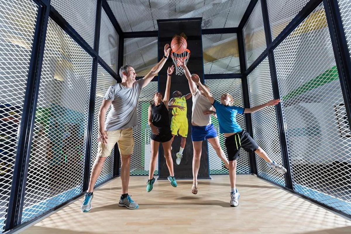 a group of people playing basketball on a net