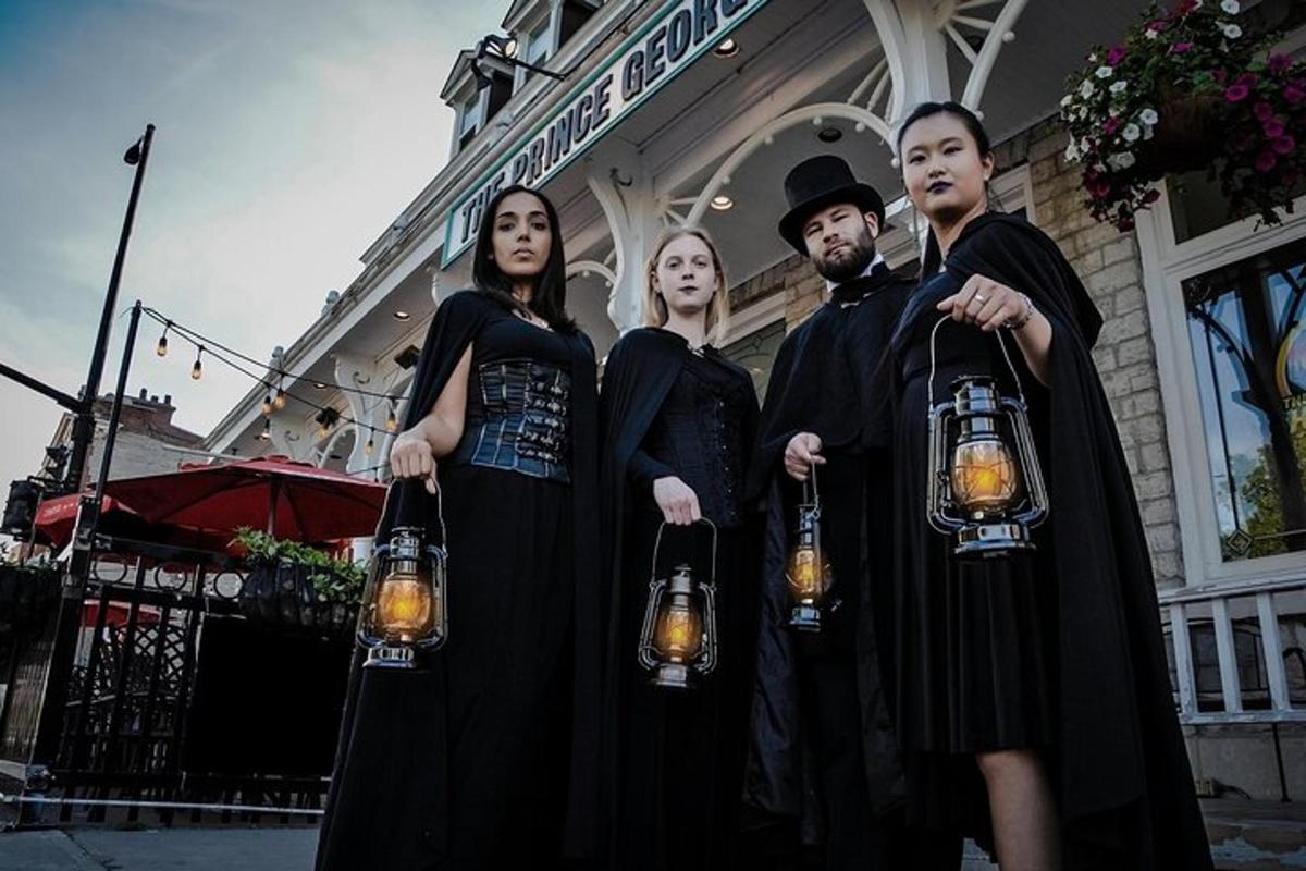 a group of people dressed in black holding lights