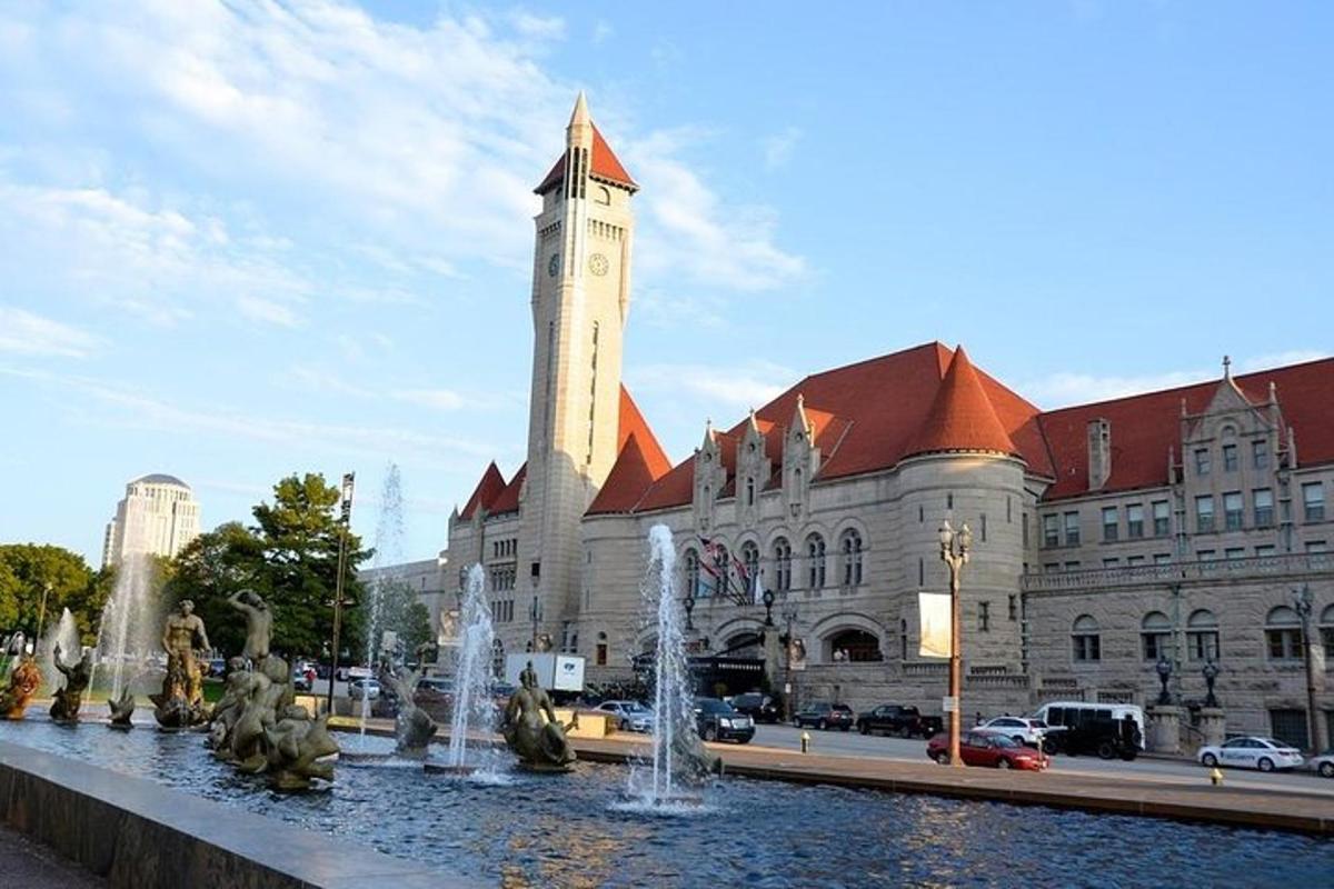 a building with a clock tower in front of a fountain
