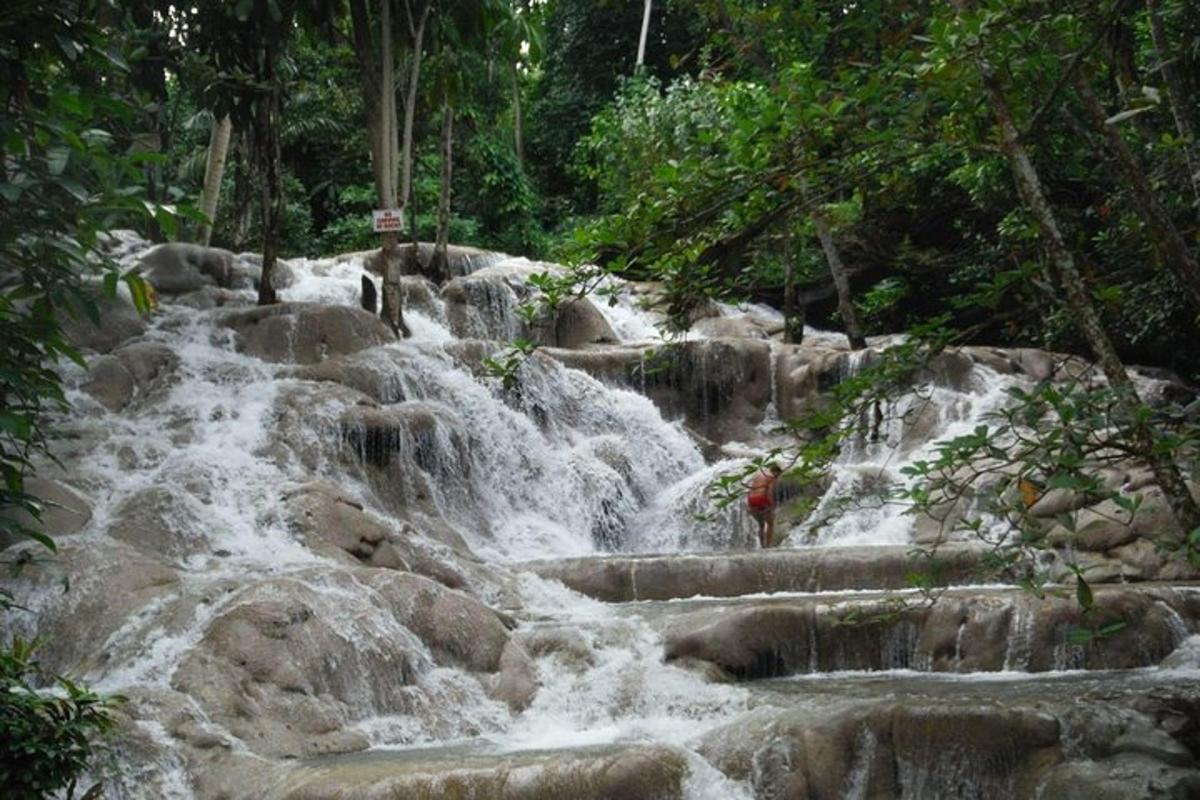 a person standing in front of a waterfall
