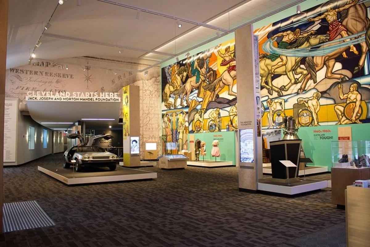 a museum with a car on a wall with a mural