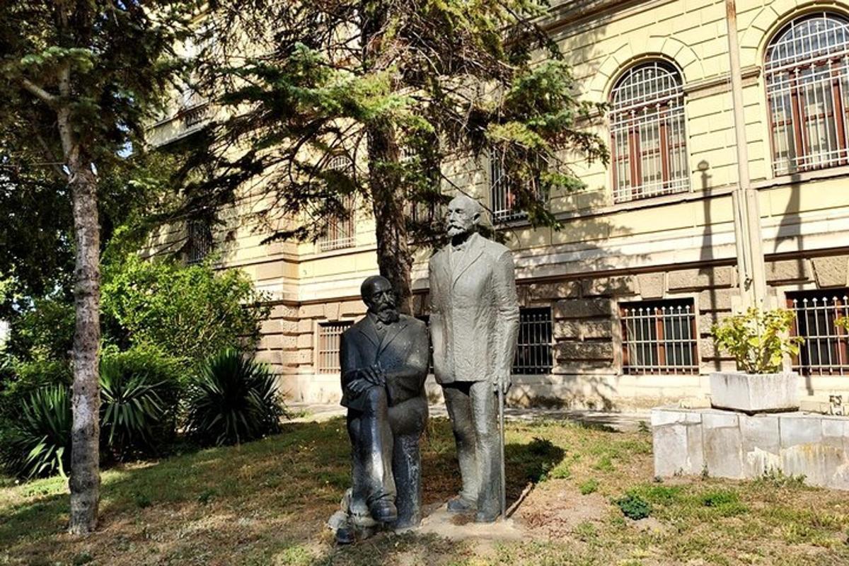 a statue of a man and a boy in front of a building