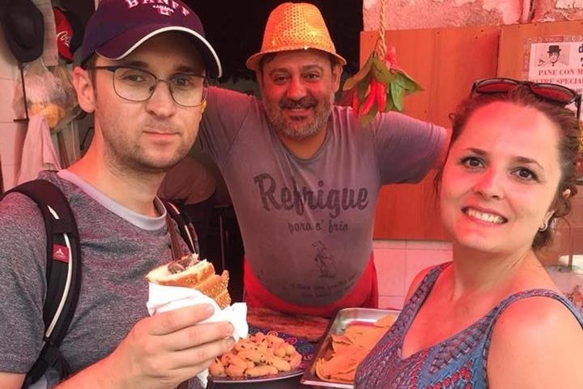 dos homes i una dona menjant davant d'una taula