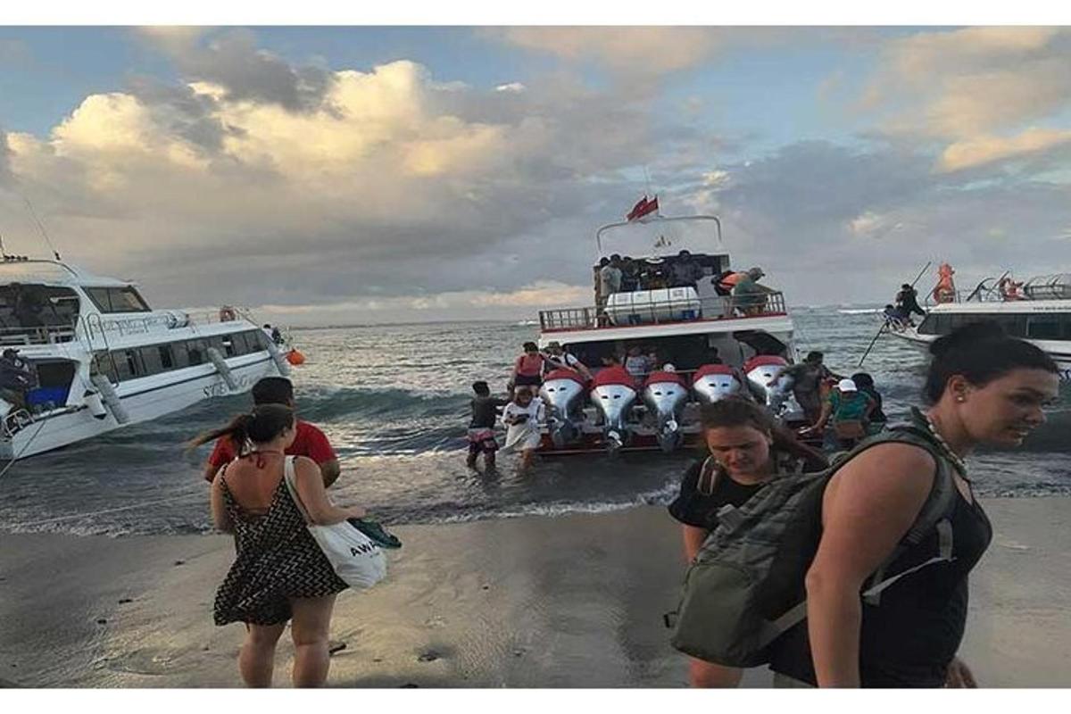 a group of people on a boat on the beach