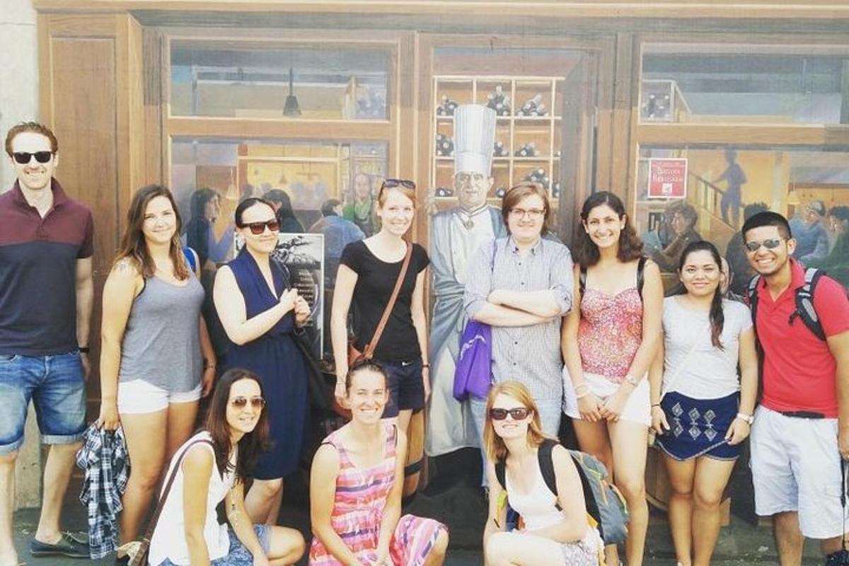 a group of people standing in front of a painting