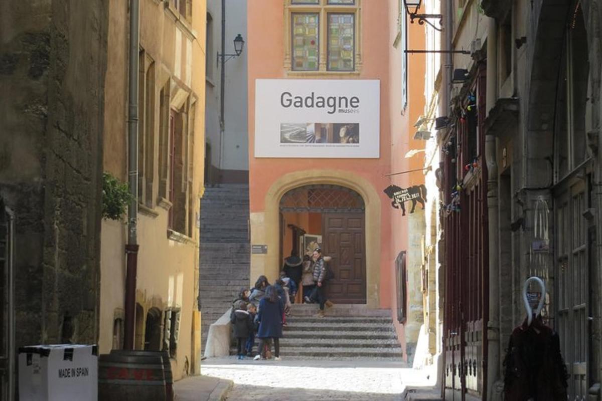 a group of people walking down the stairs in an alley