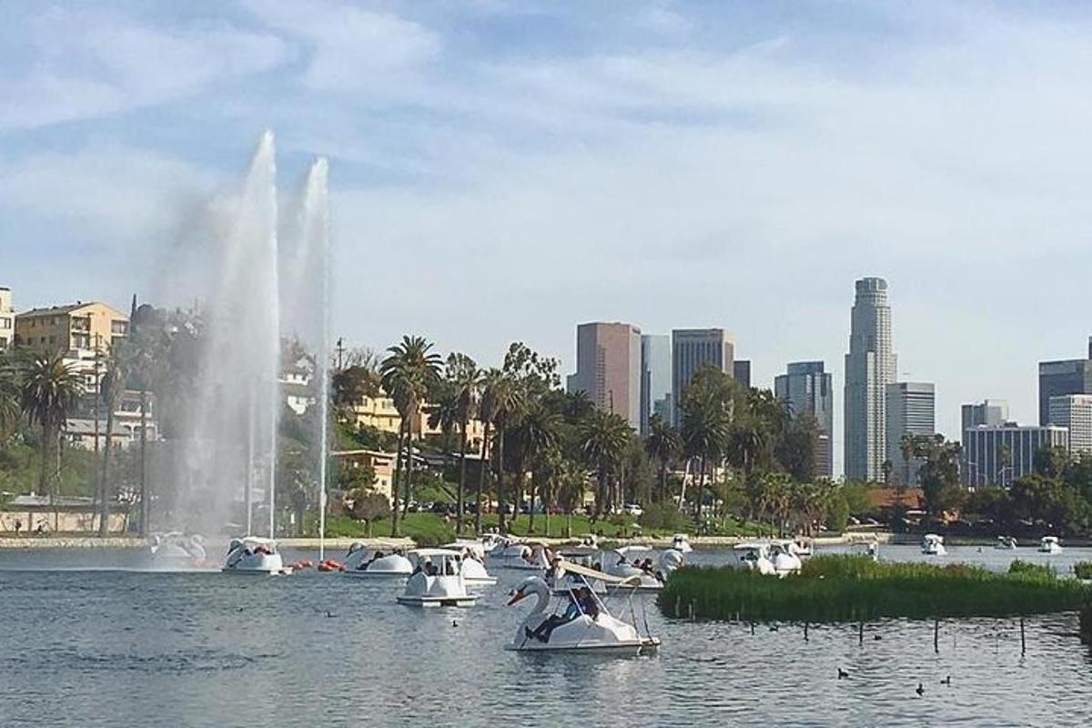 a group of boats in the water with a fountain