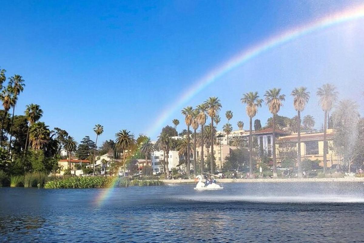 a rainbow over a lake with a boat