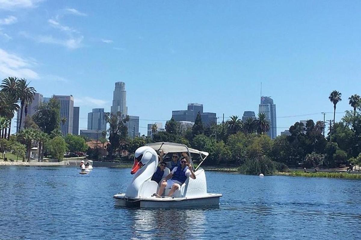 a group of people riding a swan boat in the water