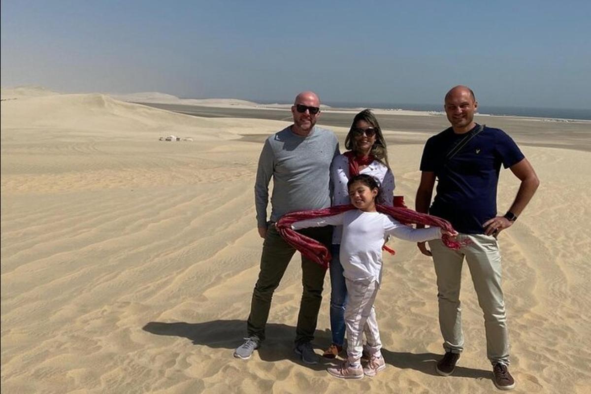 a family posing for a picture in the desert