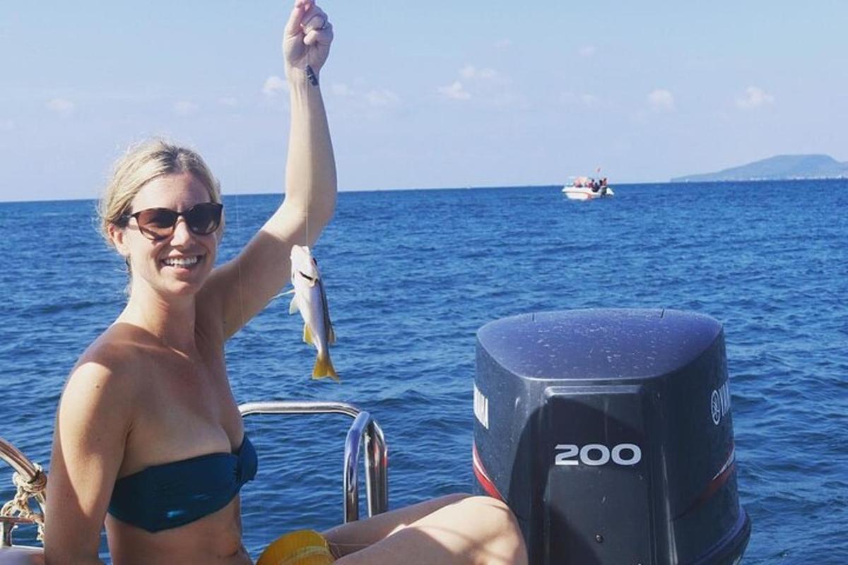 a woman in a bikini on a boat in the water
