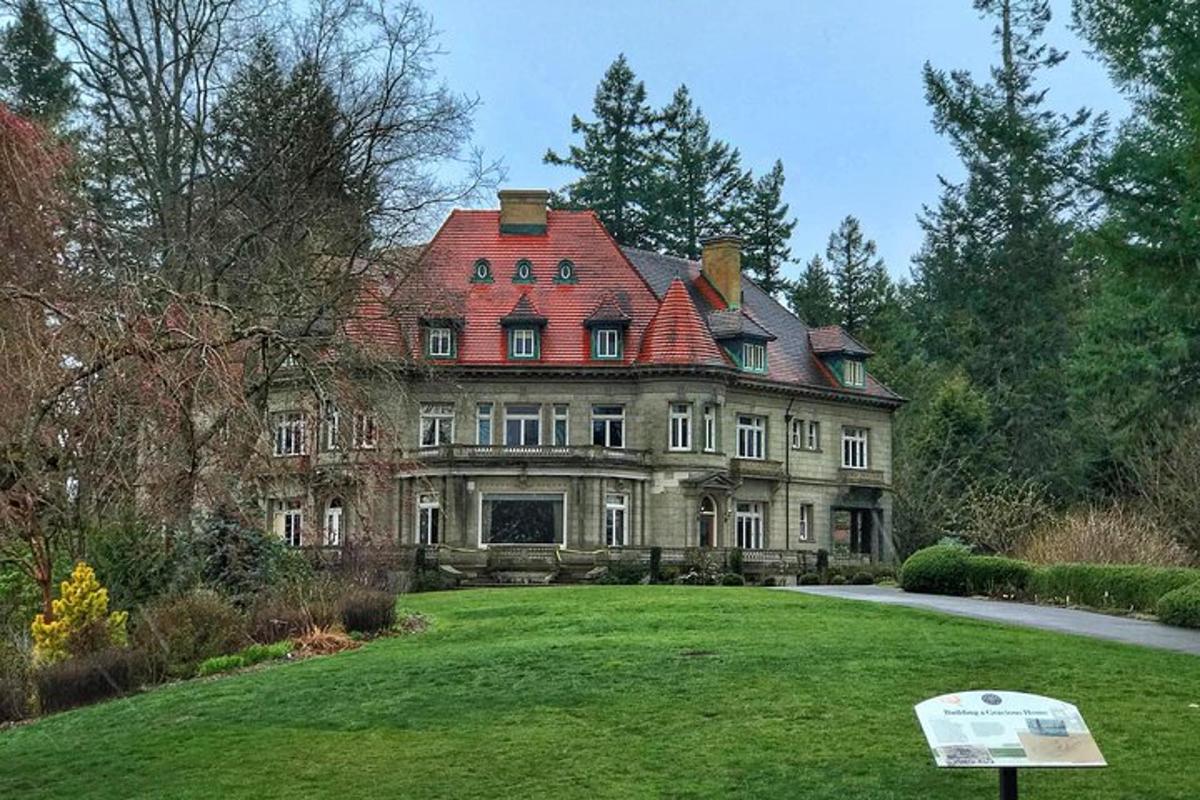 a large house with a red roof on a lawn