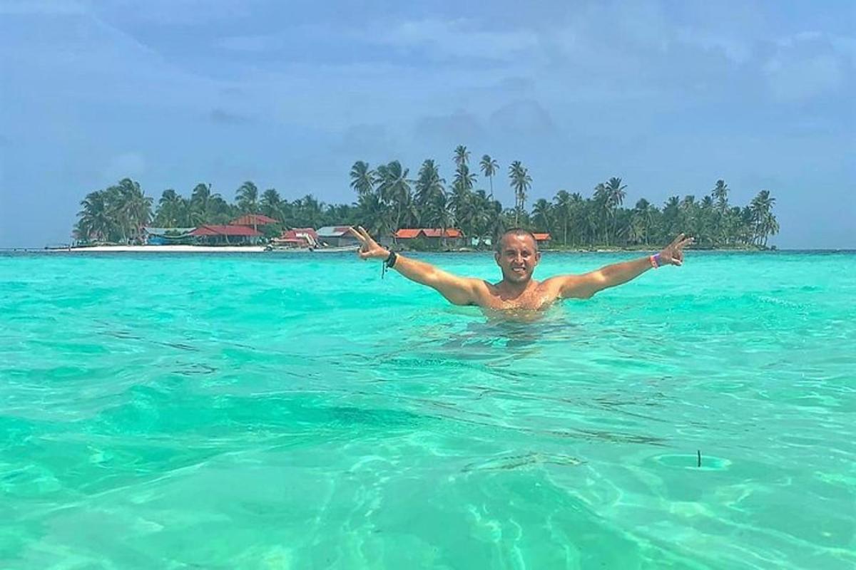 a man in the water with his arms out in the ocean