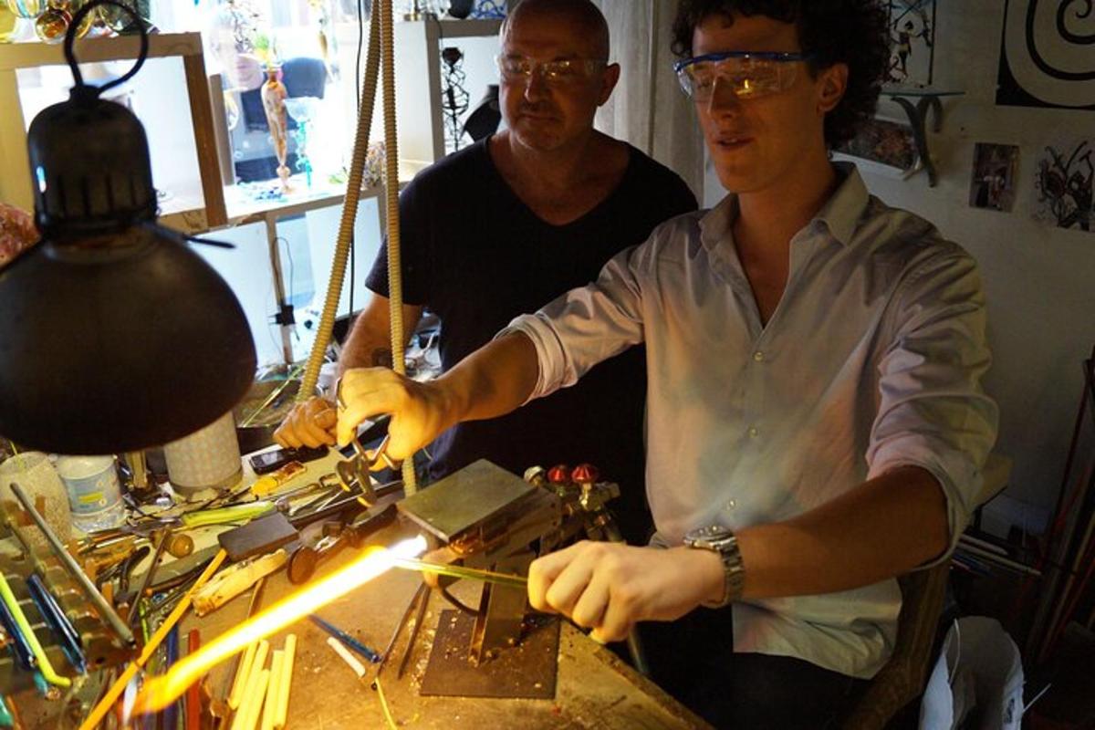 a man cutting a piece of metal on a table