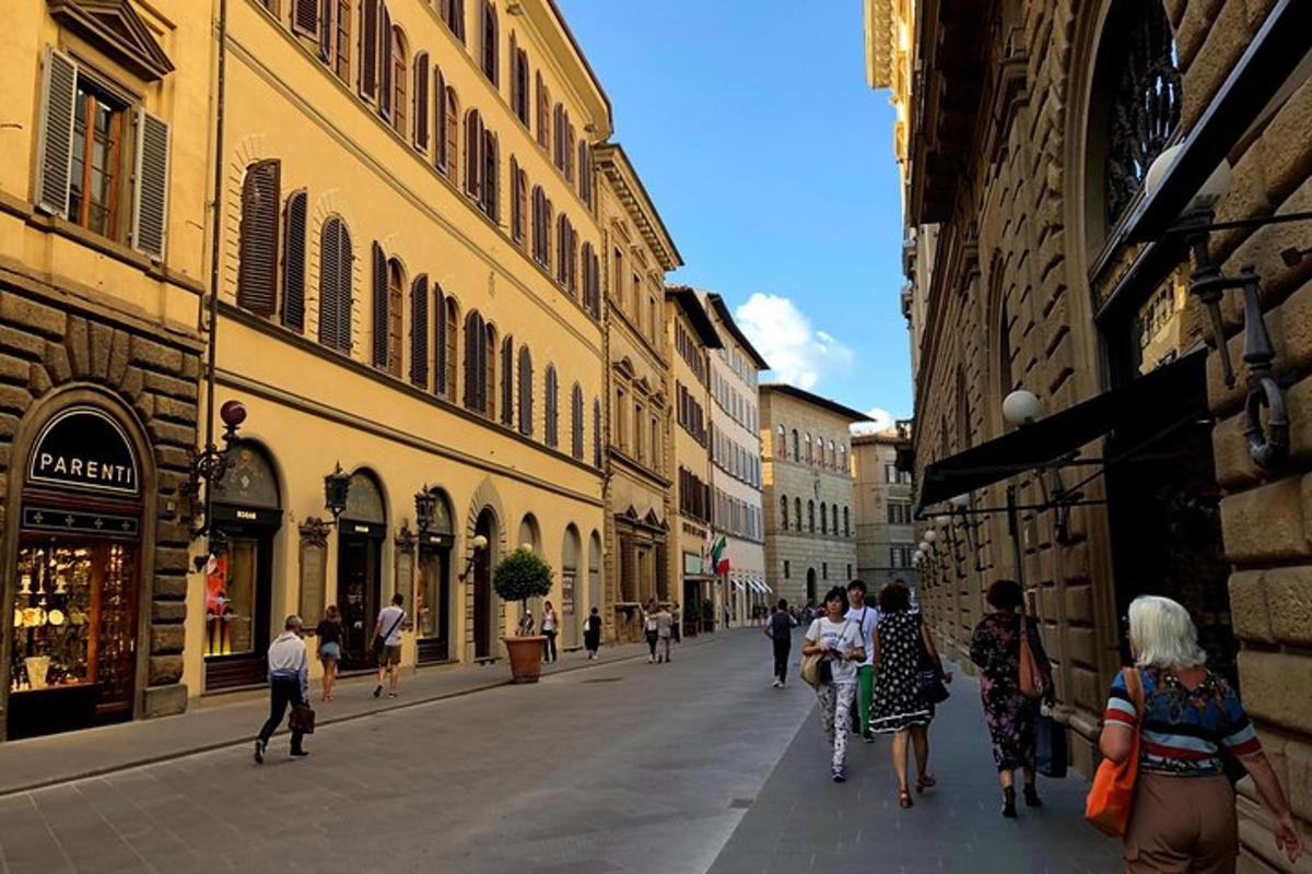 a group of people walking down a city street