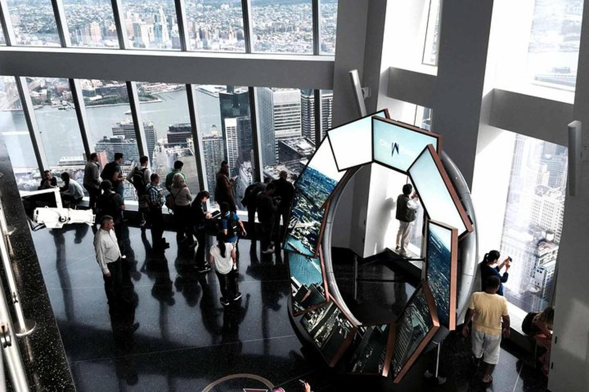 a group of people standing in a building with a mirror