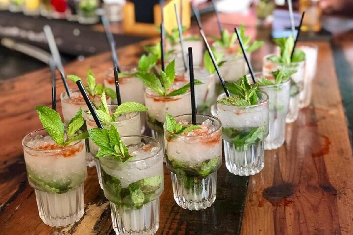 a row of glasses with plants in them on a table