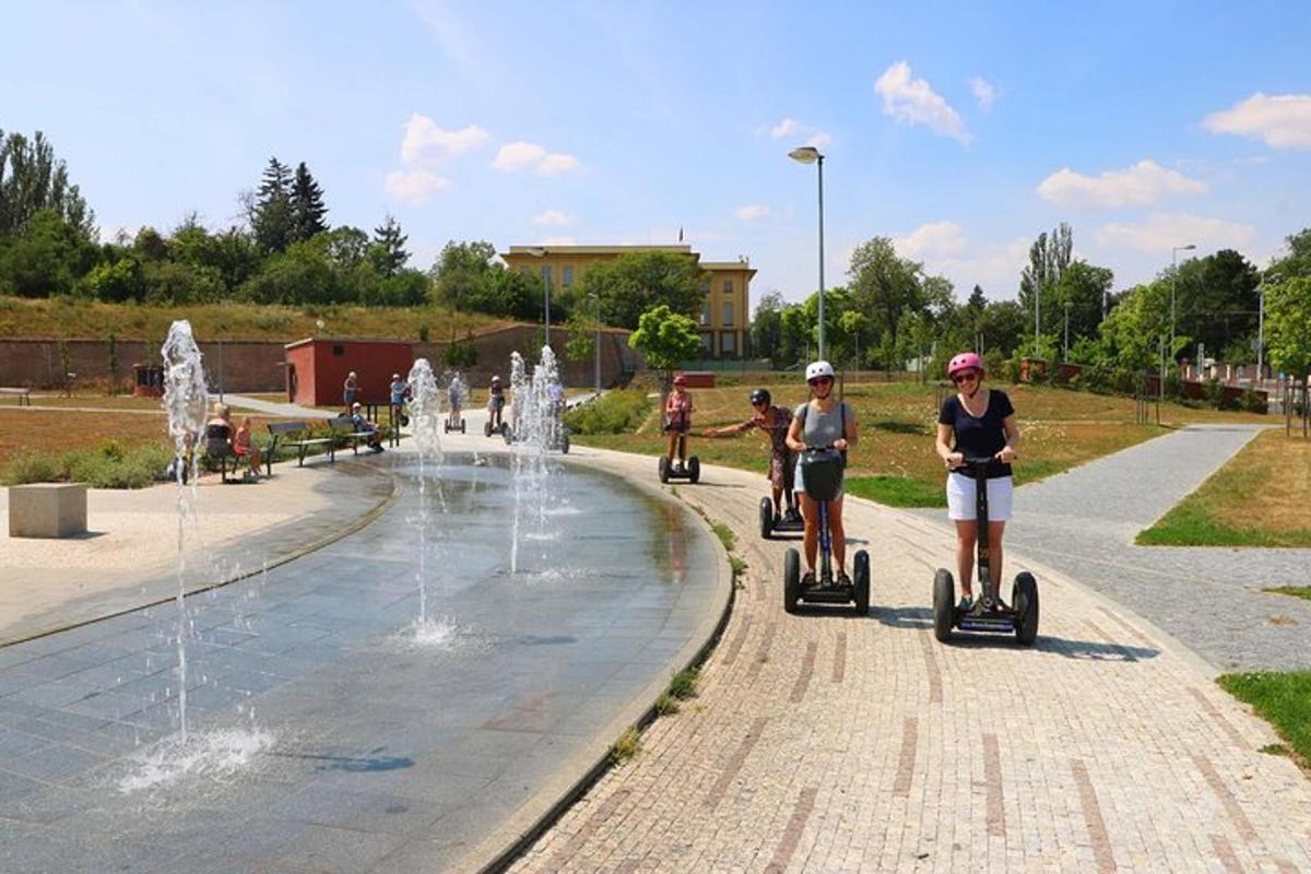 a group of people riding segways around a fountain