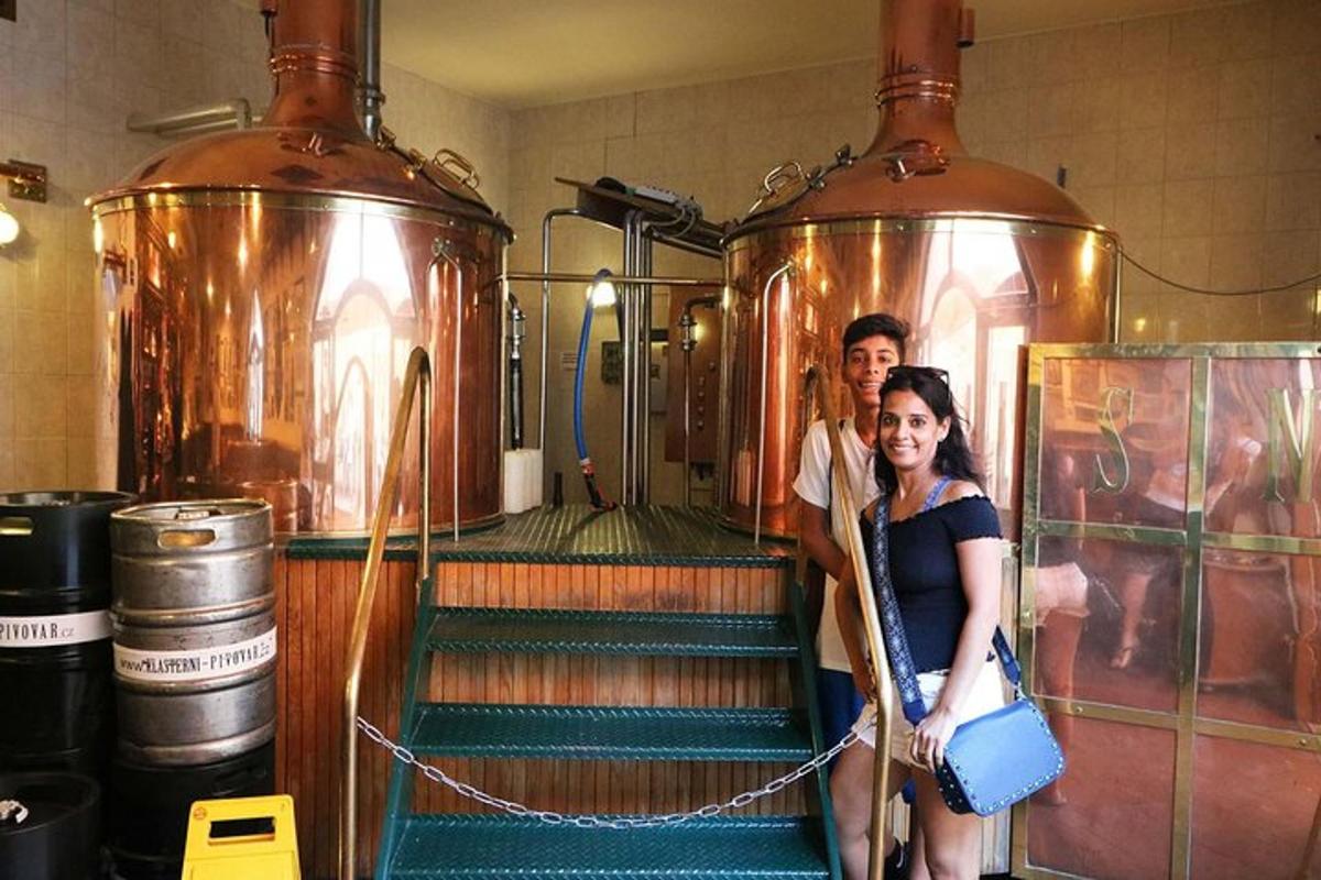 a man and a woman standing in front of a brewery