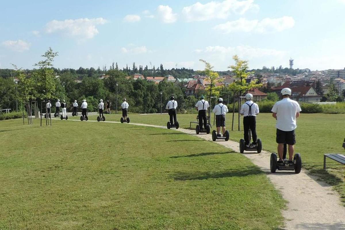 a group of people riding on segways in a park