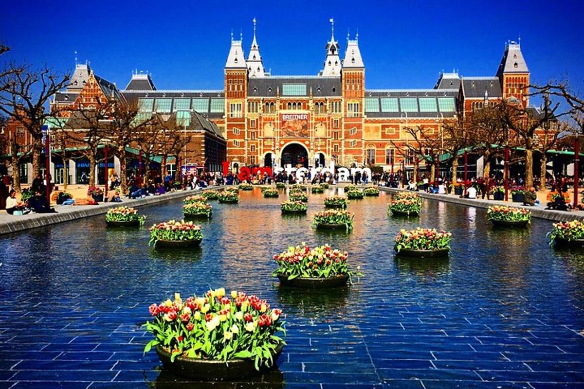 a large building with many potted plants in the water