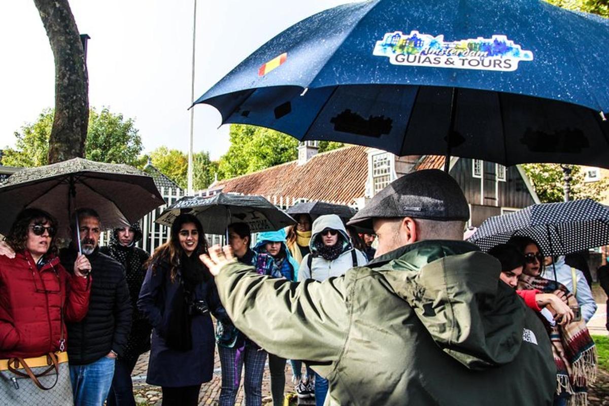 a man taking a picture of a group of people with umbrellas