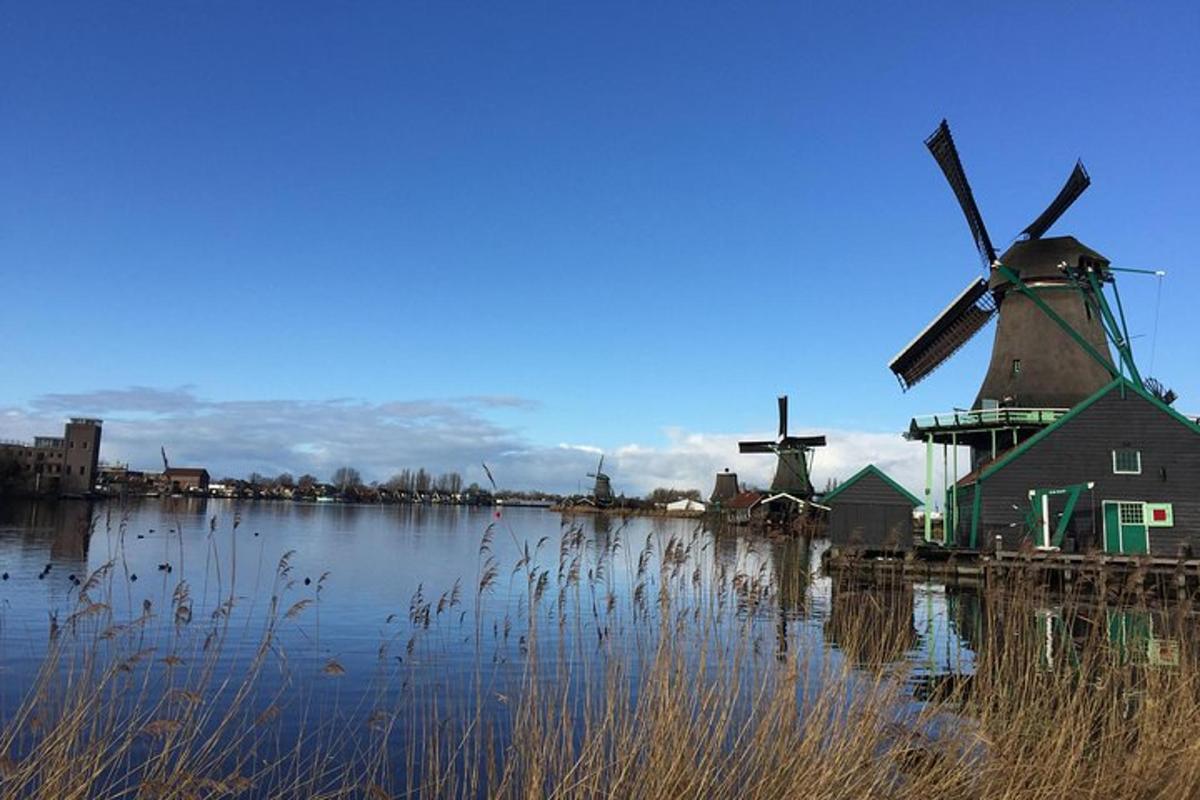 two windmills sitting in the water next to a building