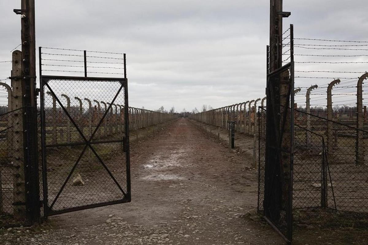 an old fence with a gate in a field