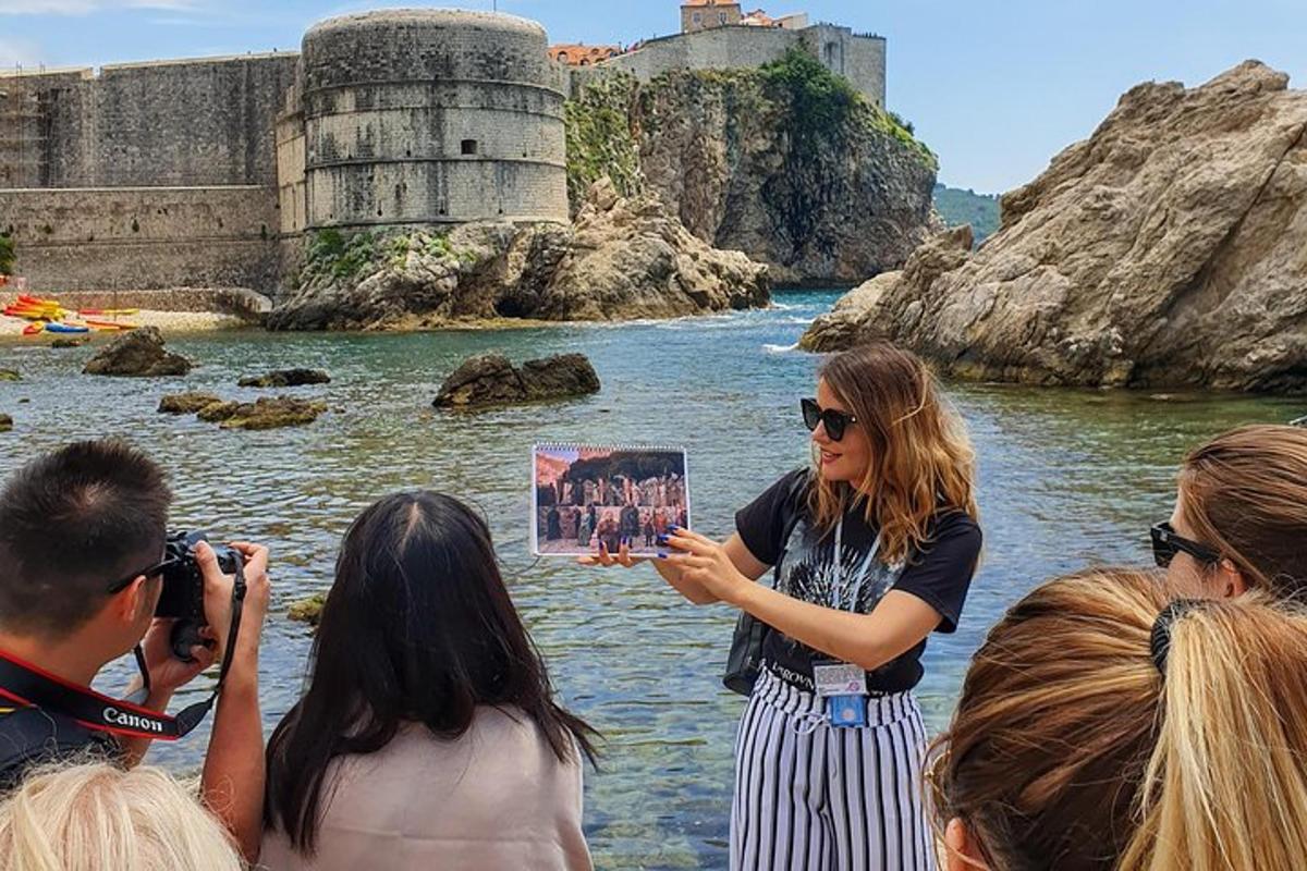 a woman standing in the water with a group of people